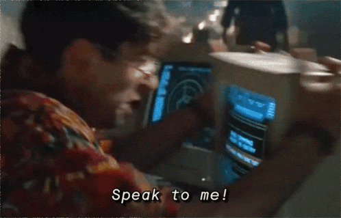 A picture of Boris from the film Goldeneye shaking a cathode ray tube (CRT) computer and shouting "Speak to me!" 